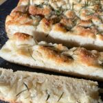 Super easy focaccia bread recipe made with simple ingredients! This amazing rosemary bread is perfect for serving with dinner or as a yummy snack for family gatherings.