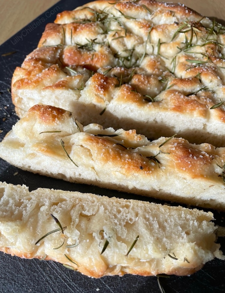 Super easy focaccia bread recipe made with simple ingredients! This amazing rosemary bread is perfect for serving with dinner or as a yummy snack for family gatherings. 