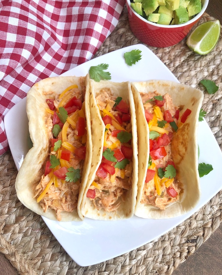 How to make creamy shredded salsa chicken in your crockpot with just 4 ingredients! A yummy way to make tacos for your family. 