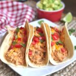 How to make creamy salsa shredded chicken tacos in your slow cooker! My family loves this easy weeknight dinner. Serve in warm flour tortillas to make the best homemade chicken tacos. Picky eater approved!