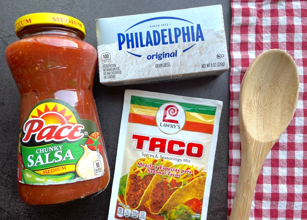 Slow cooker shredded chicken tacos made with salsa, cream cheese, and taco seasoning.