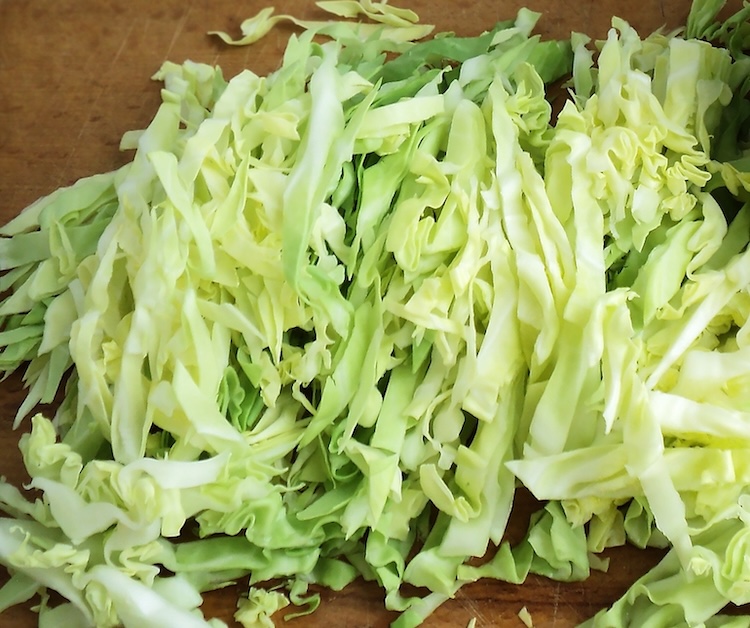 Chopped cabbage on a cutting board. 